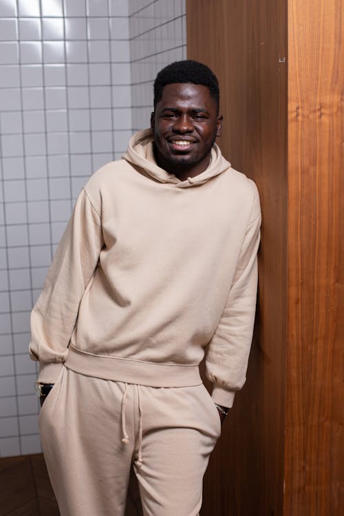 Cheerful black man standing in tiled room