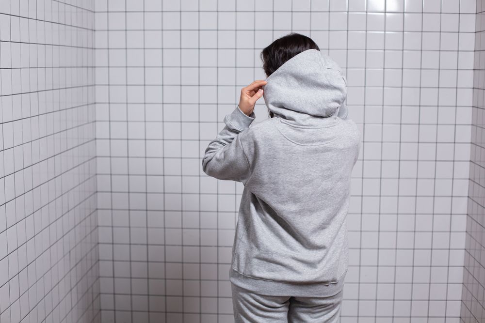 Provisional streetwear journal photograph of a woman in a hoodie.