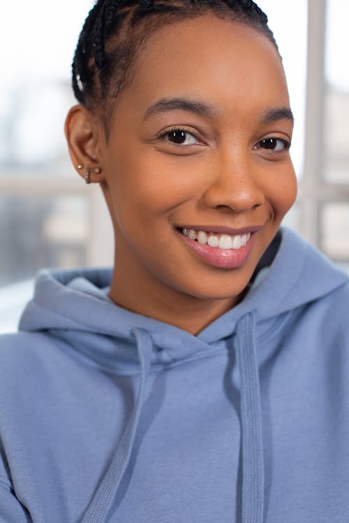 Smiling black woman in fashionable blue hoodie