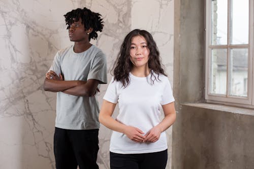 Pleasant young Asian woman with pensive black man