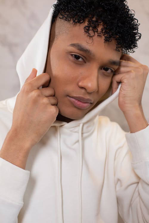 Black man with curly hair in hood