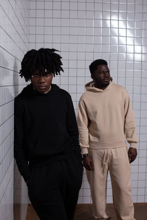 Confident African American men standing at tiled wall