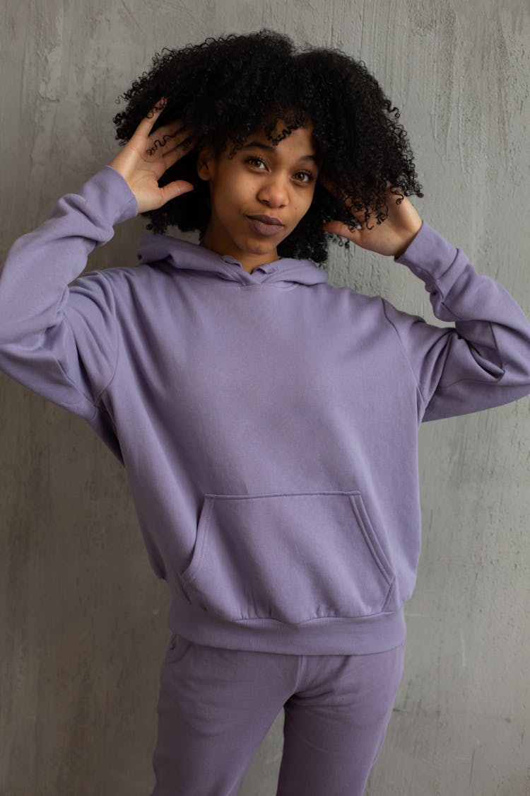 Confident Young Ethnic Woman Touching Afro Hair And Looking At Camera