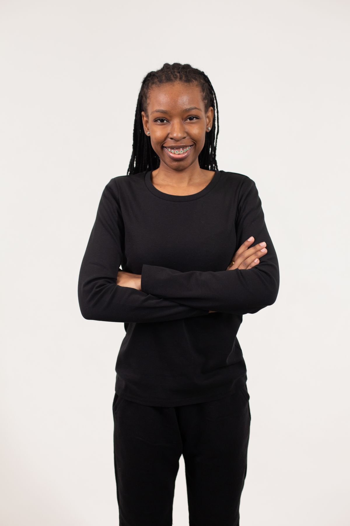 Confident young Black woman standing with folded arms