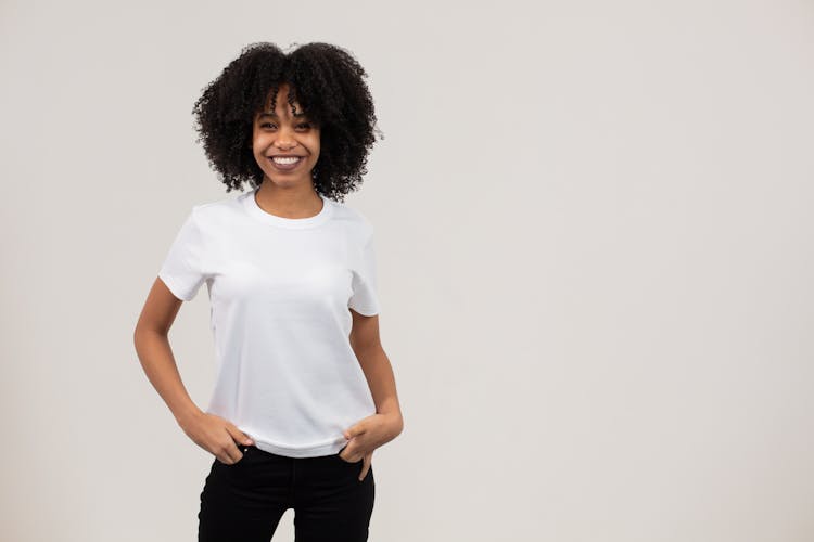 Happy Young African American Lady Smiling At Camera Against White Background