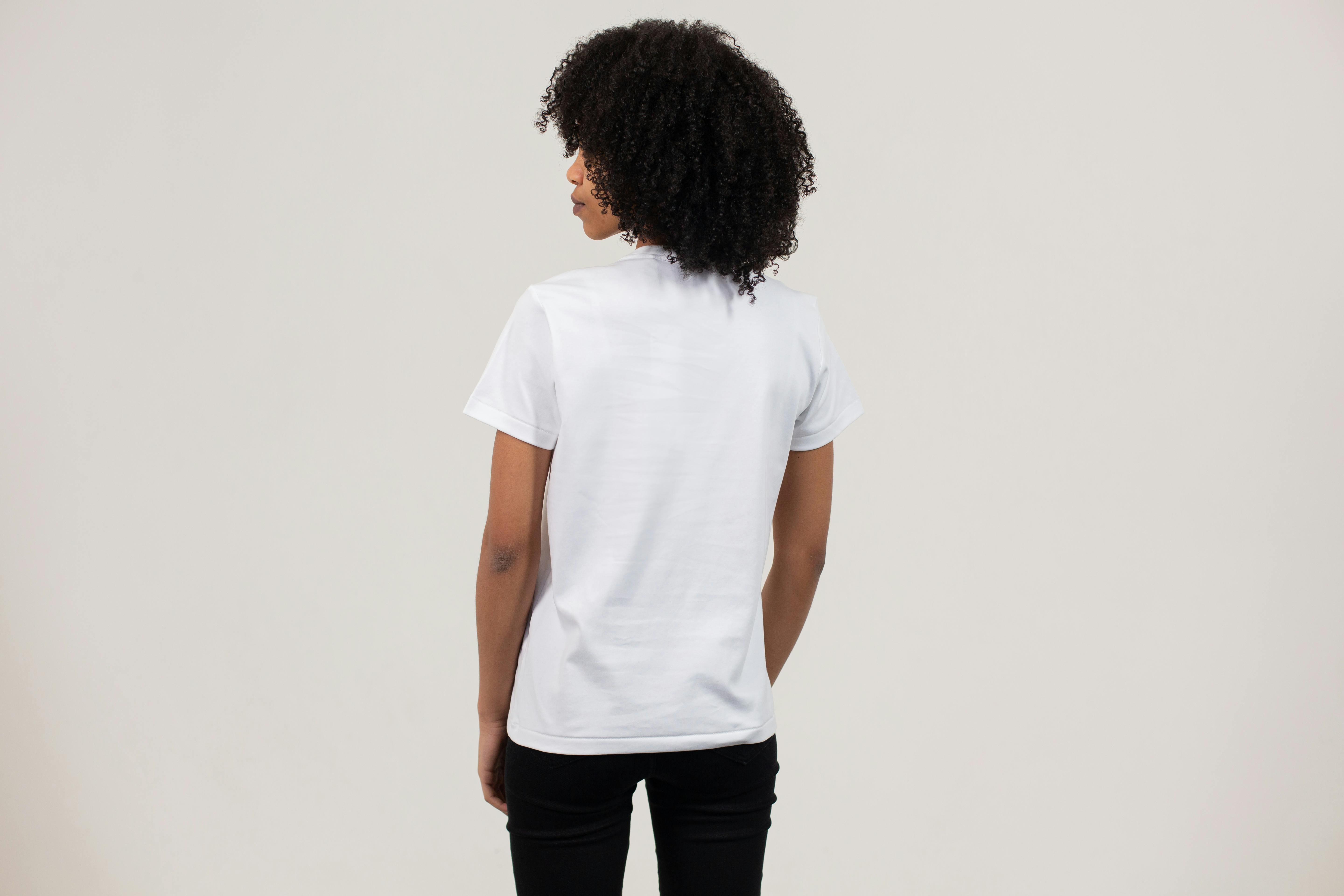 black woman in casual t shirt against white wall