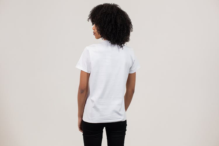 Black Woman In Casual T Shirt Against White Wall