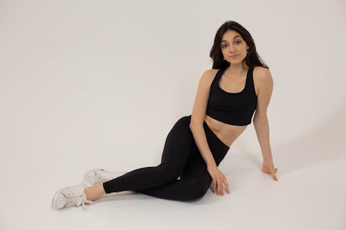 Lady sitting on white background in studio