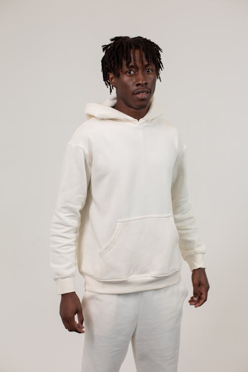 Unemotional African American man in hoodie in studio