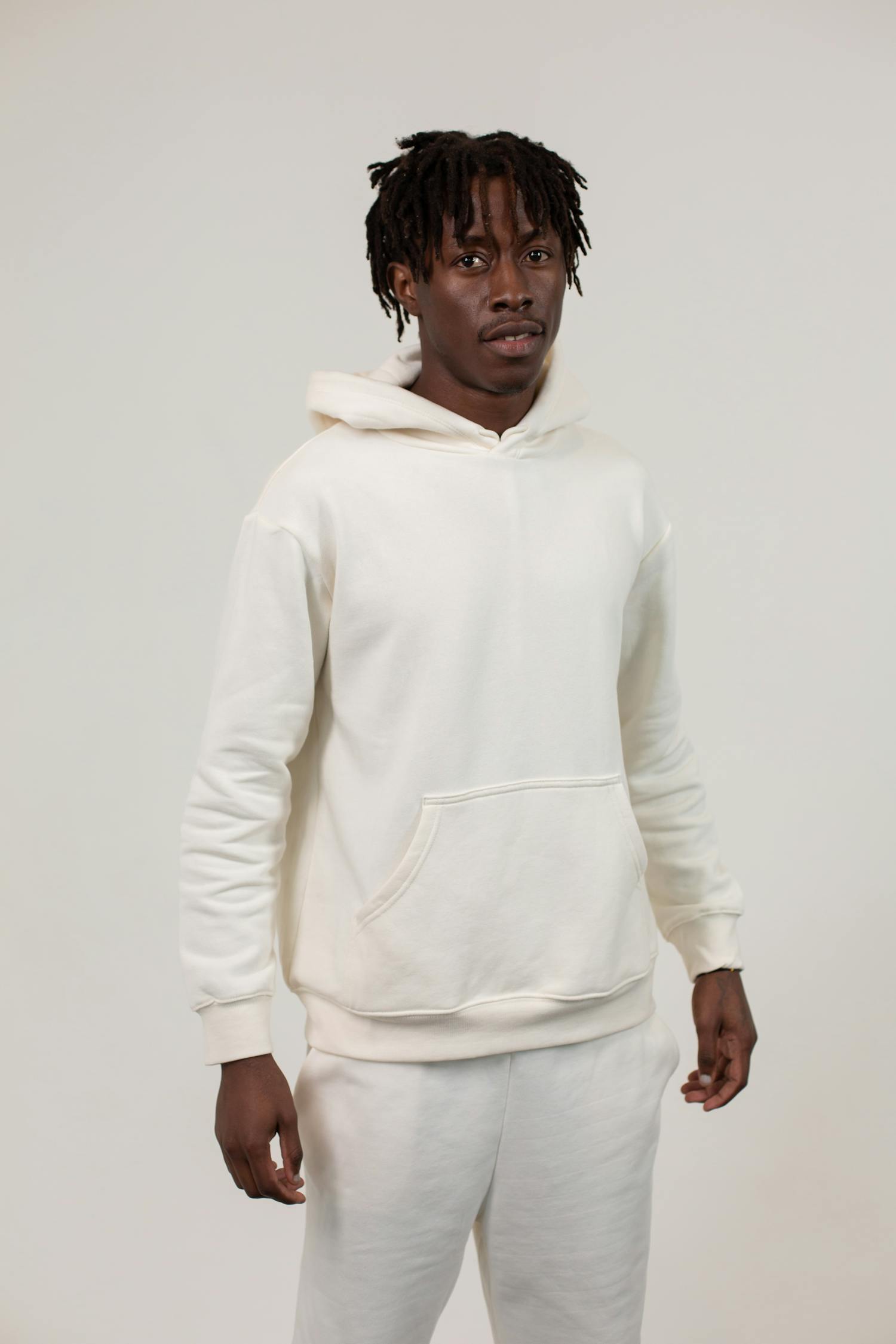Unemotional African American man in hoodie in studio · Free Stock Photo