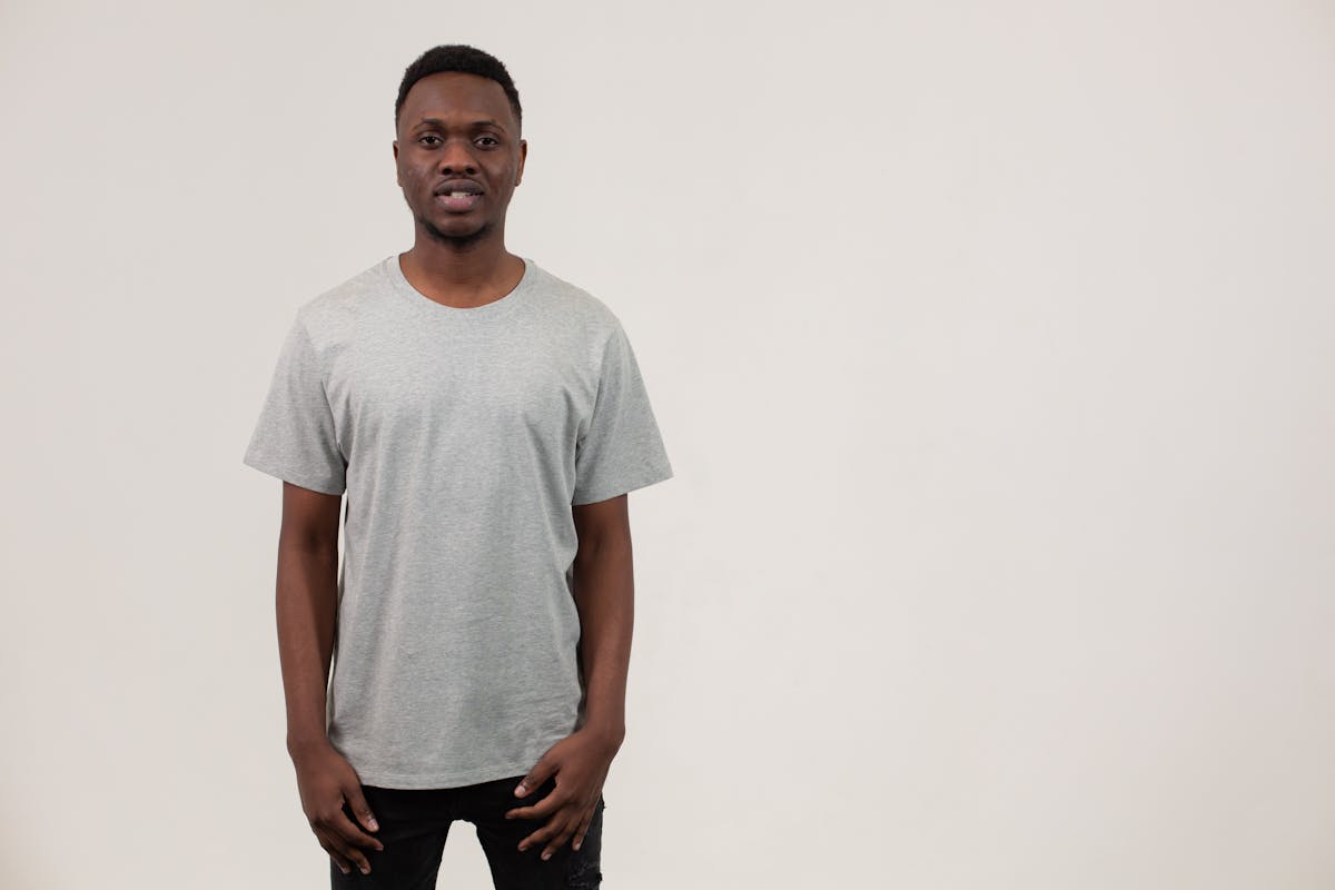 Minimal winter outfit in neutral shades laid out on a bed