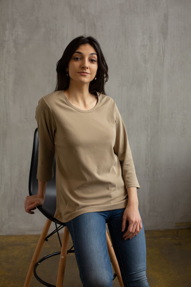 Woman wearing a beige long-sleeve tee