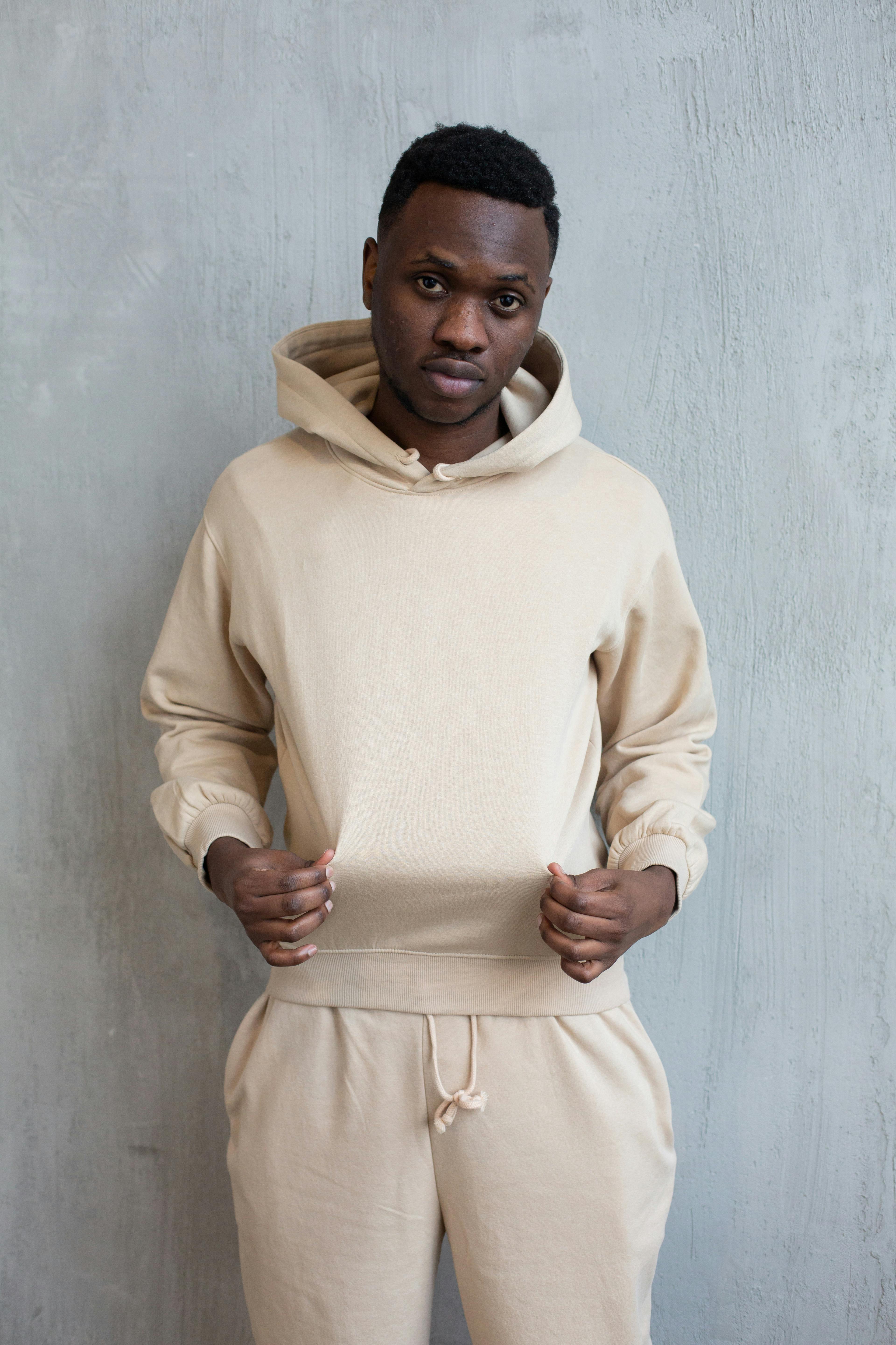 self confident black man in beige hoodie