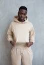 Self confident black man in beige hoodie