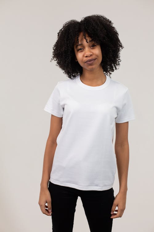 Smiling black woman in white t shirt and tight pants · Free Stock Photo