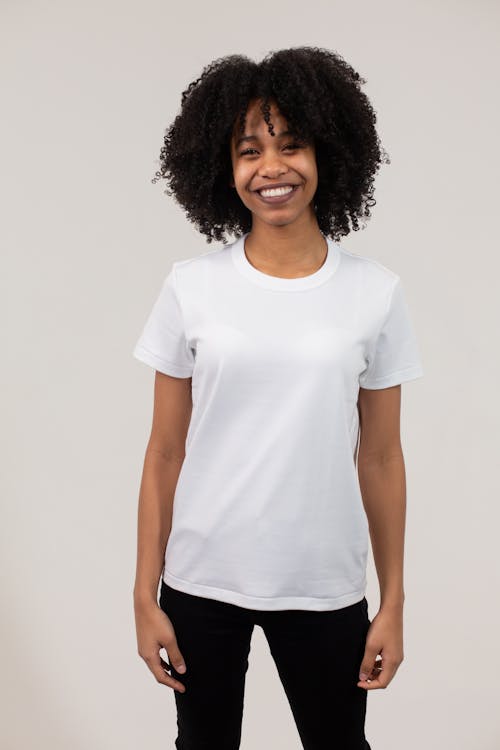 Cheerful Black Woman Wearing White T Shirt And Pants · Free Stock Photo