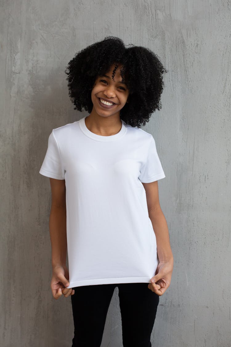 Cheerful Black Woman In White T Shirt In Studio