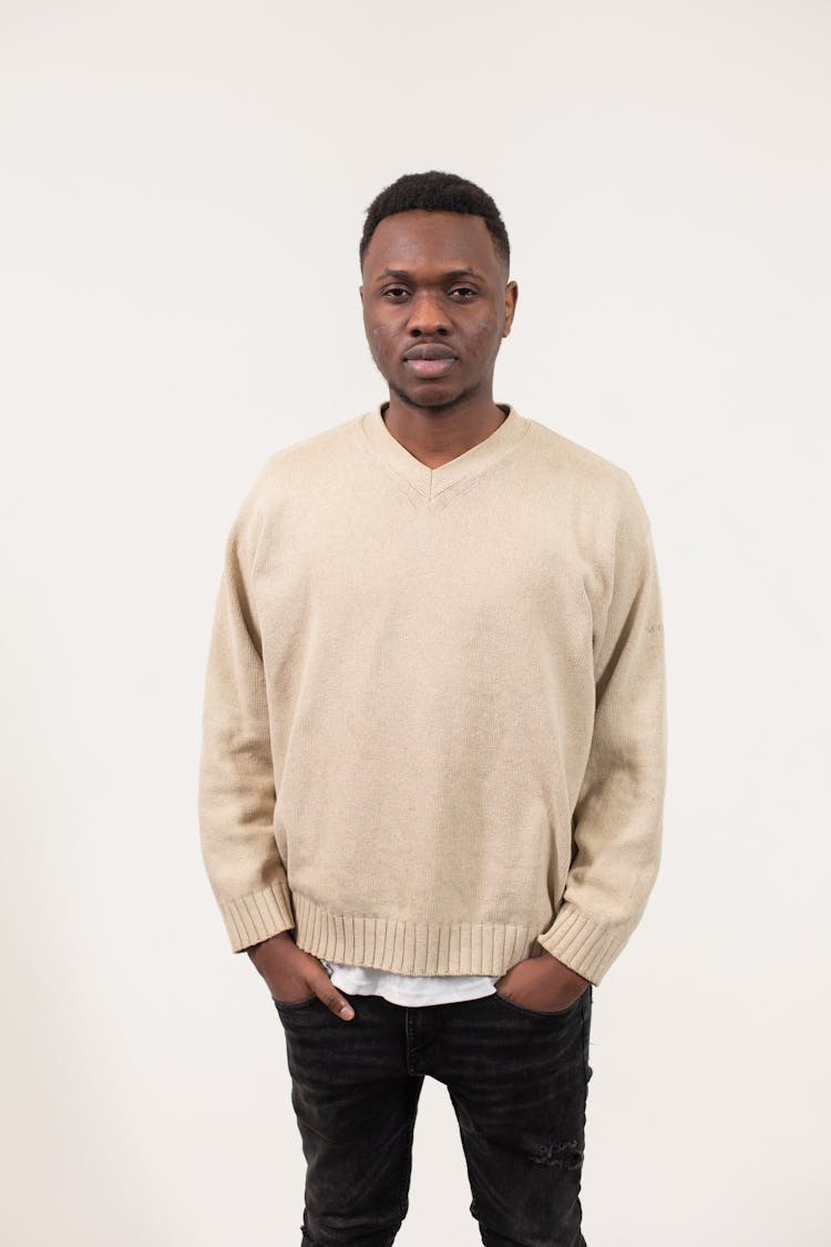 Serious Black Man In Pullover In Studio