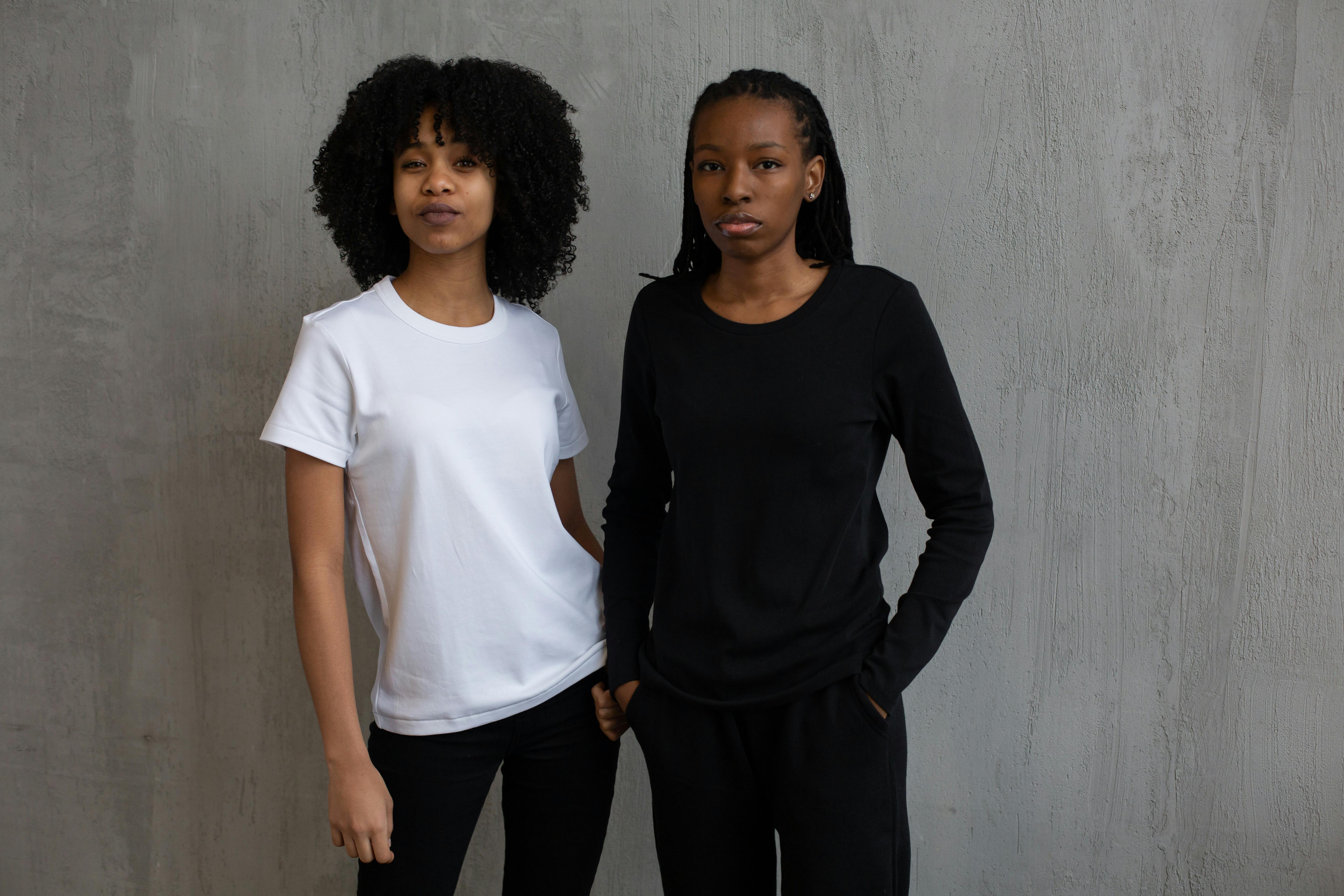 Upcycled denim pieces including a panel-insert skirt and patchwork jeans styled with simple tops on a minimalist clothing rack