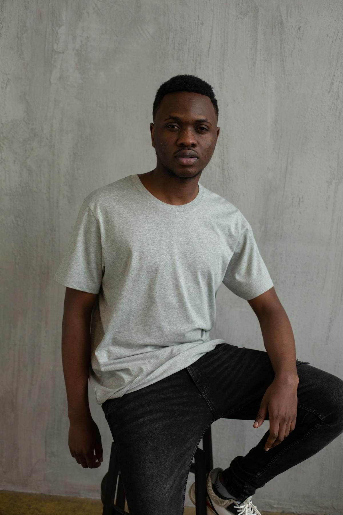 Minimal clothing rack with coordinated neutral capsule wardrobe pieces including shirts, trousers, and jackets