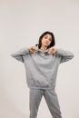 Young woman wearing oversize hoodie and pants