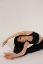 Graceful woman bending aside sitting in split