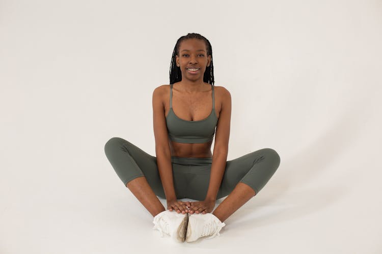 Fit Black Woman Sitting In Baddha Konasana Pose