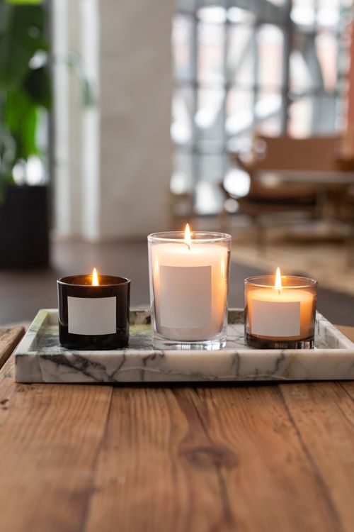 Free A close-up of burning candles on a wooden table with a soft, warm ambiance. Stock Photo
