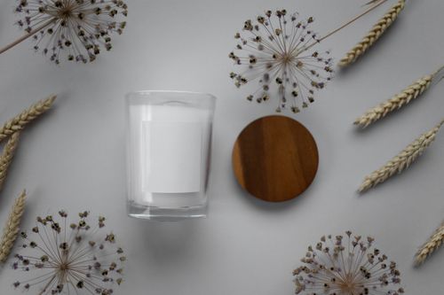 Free Aesthetic minimalist flat lay featuring a candle and dried flowers on a gray background. Stock Photo