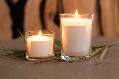 Free Burning Candles on Glass Containers Stock Photo