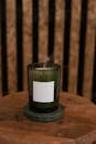 Unlit Candle in Green Glass Candle Jar