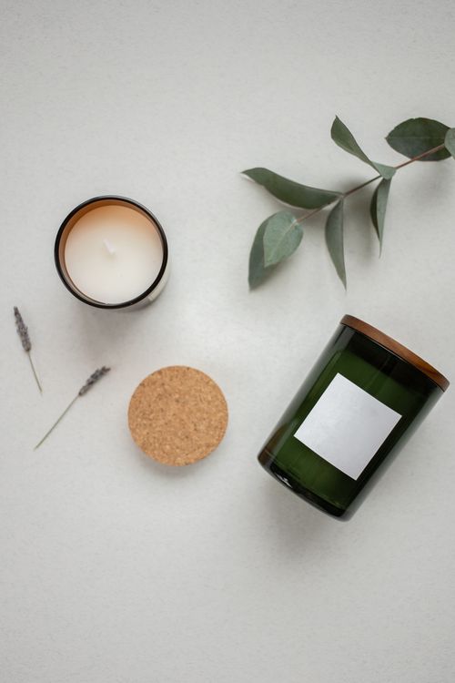 Free Elegant flat lay featuring candles and eucalyptus leaves for a serene ambiance. Stock Photo