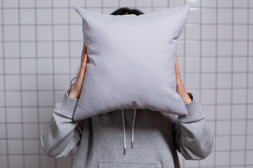 Close-Up Shot of a Person Holding a Pillow