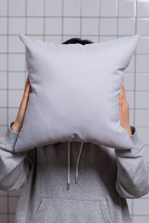 Close-Up Shot of a Person Holding a Pillow