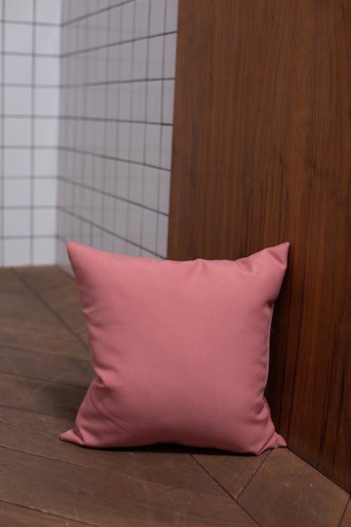 Pink Throw Pillow Lying on the Floor