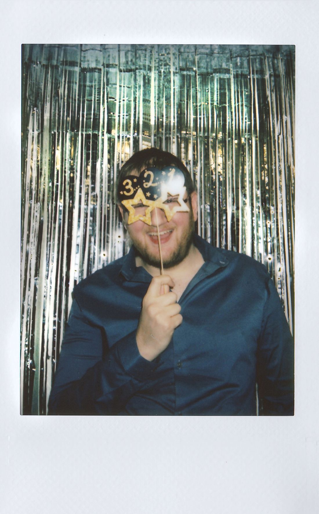 Guest having fun at the photo booth with a star-shaped glasses prop