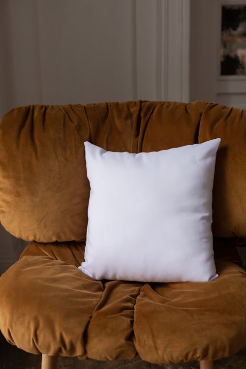 Brown Chair and a Throw Pillow