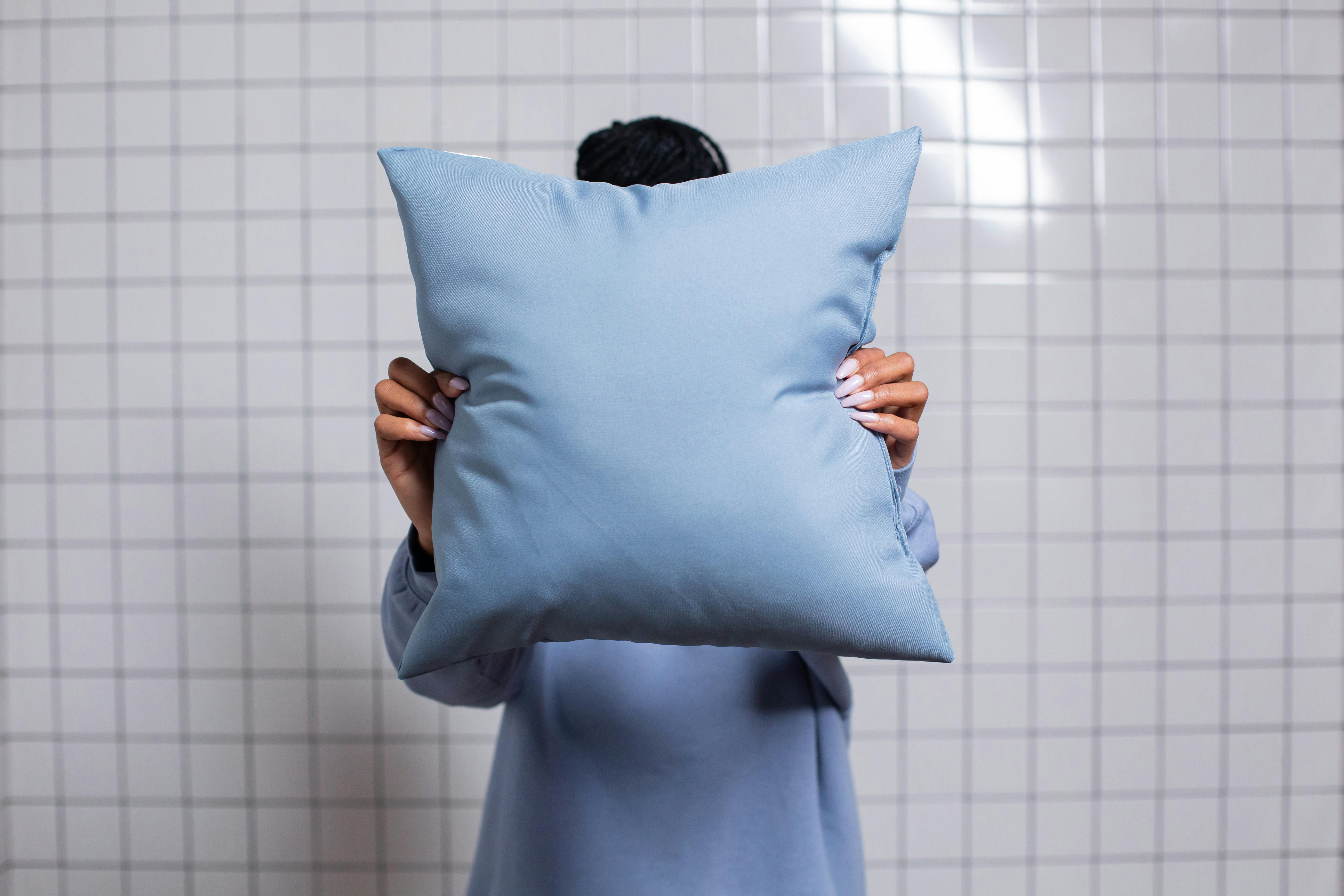 person holding a throw pillow