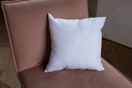 Close-Up Shot of a White Pillow on a Chair