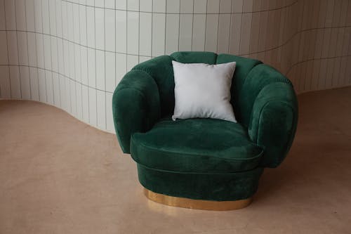 Green Sofa and White Throw Pillow