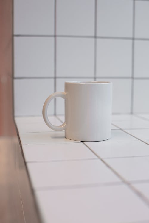 Close up of a Cup on White Tiles