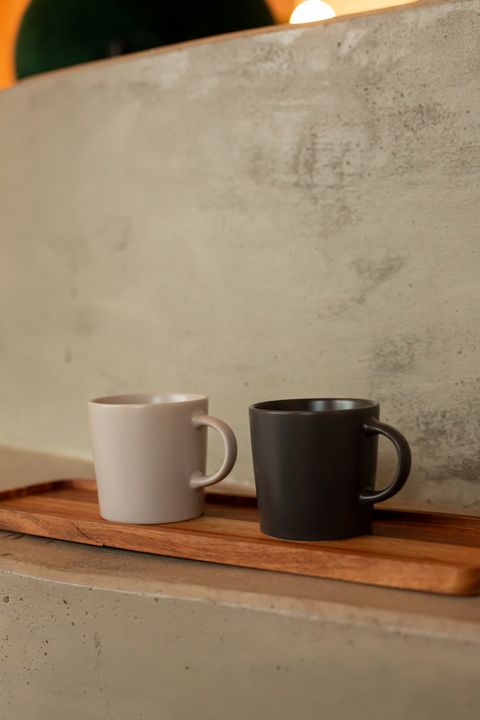 Blush and charcoal ceramic mugs on a wooden tray