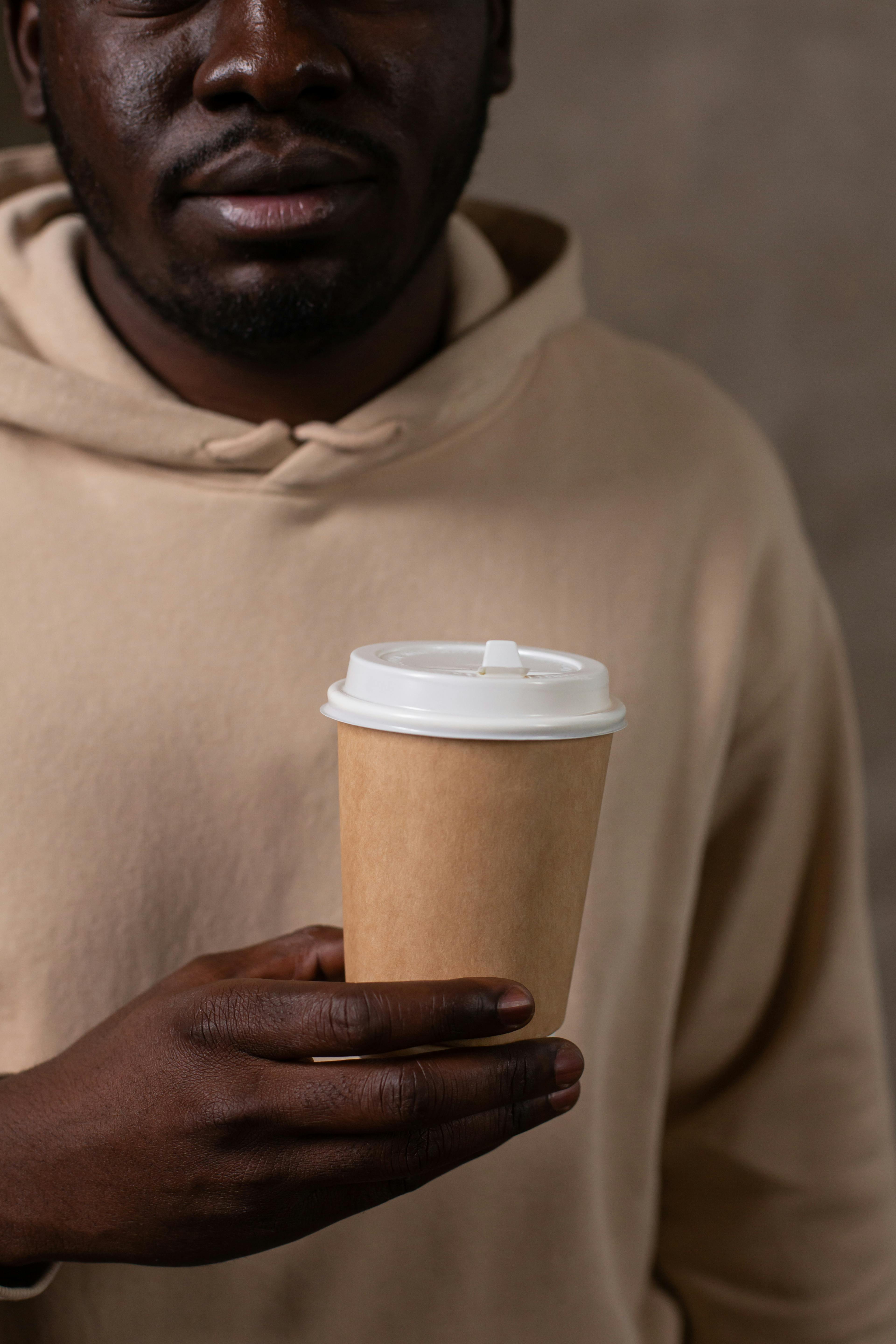 Woman in White Tube Top Holding a Paper Cup · Free Stock Photo