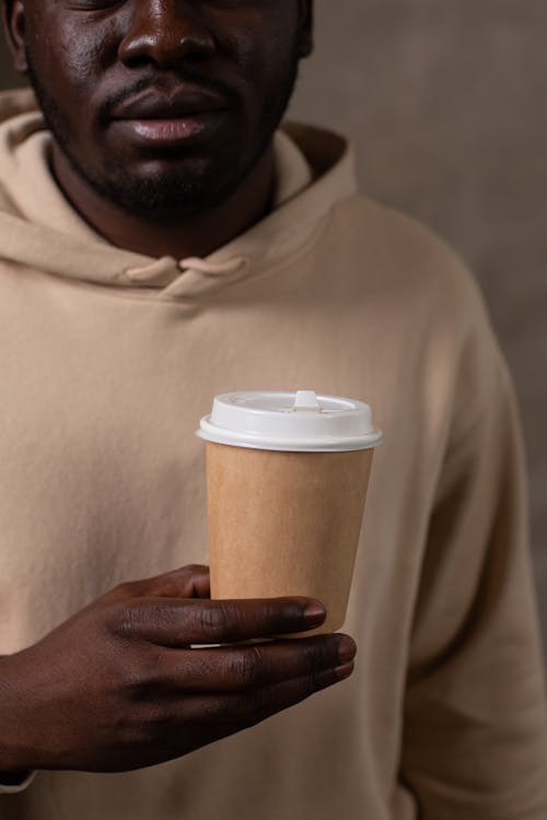 Woman in White Tube Top Holding a Paper Cup · Free Stock Photo
