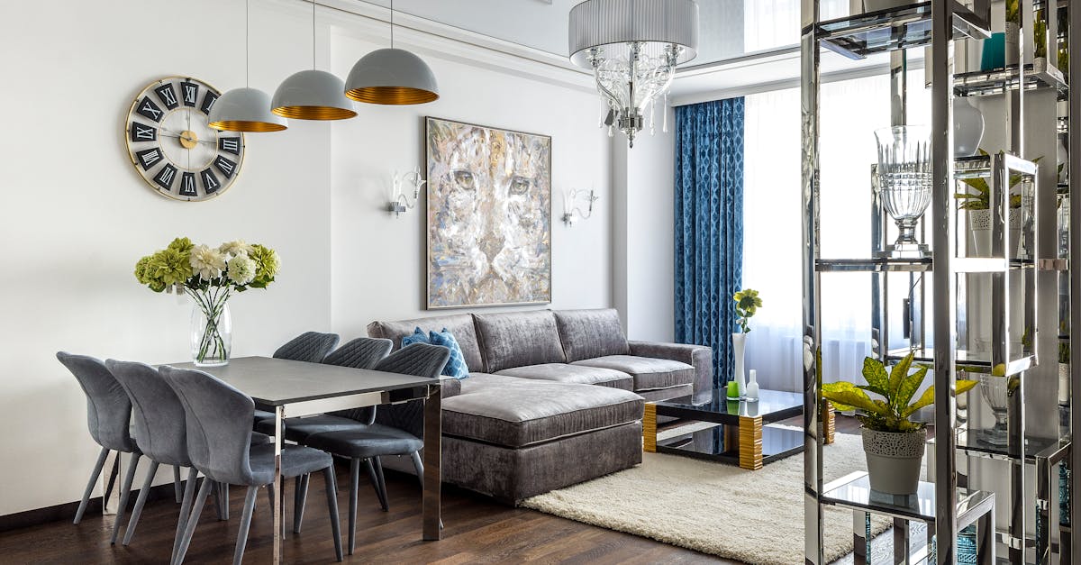 Modern interior design of spacious living room with dining zone and soft couch with pillows in studio