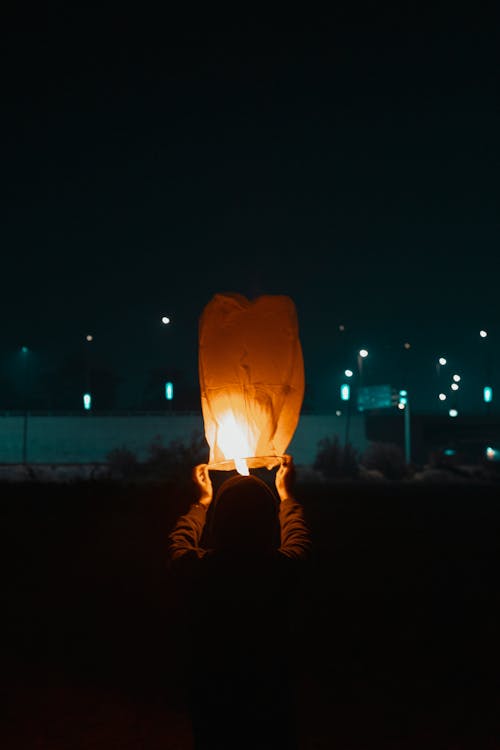 Free A Person Holding Flying Lantern Stock Photo