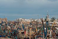 Old boats moored on embankment of seaport