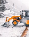 Backhoe Loader Loading Snow From the Ground