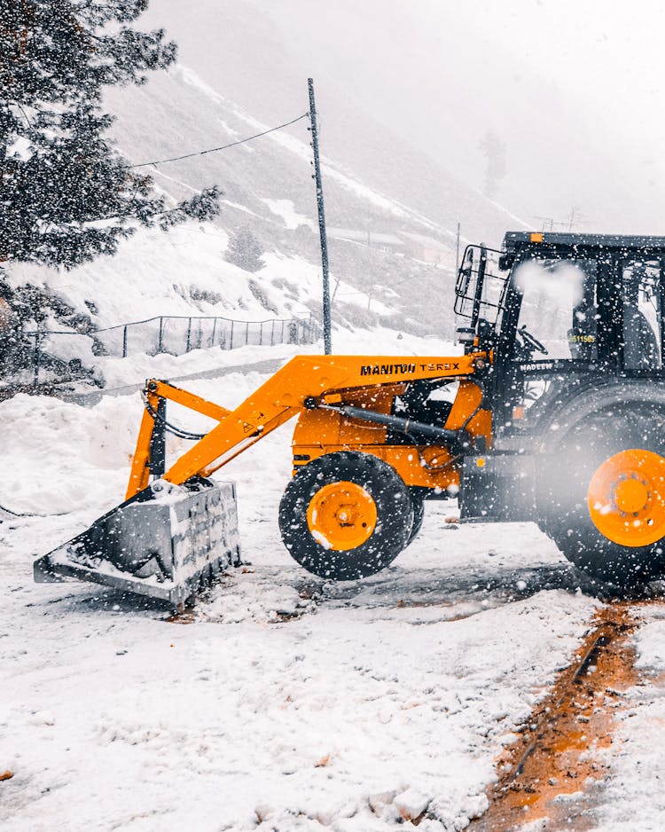 Backhoe Loader Loading Snow From The Ground