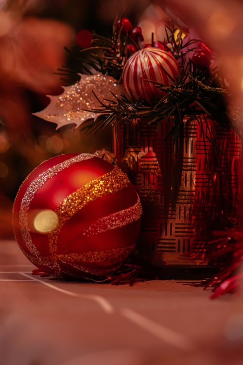 Free Warm and inviting close-up of shimmering red and gold Christmas ornaments among festive decorations. Stock Photo